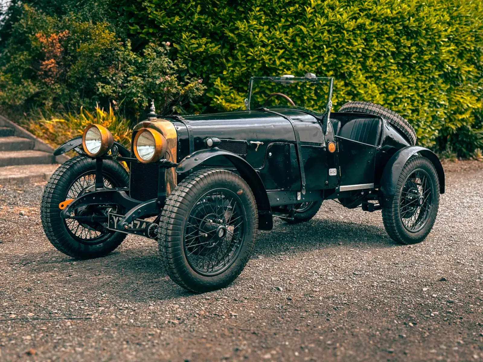 Vintage Alvis car parked on gravel